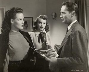 Janis Carter, Janet Blair and Franchot Tone in I Love Trouble.